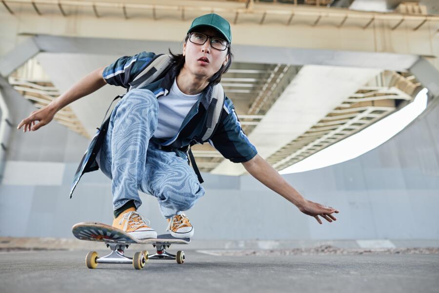 Asian man skateboarding