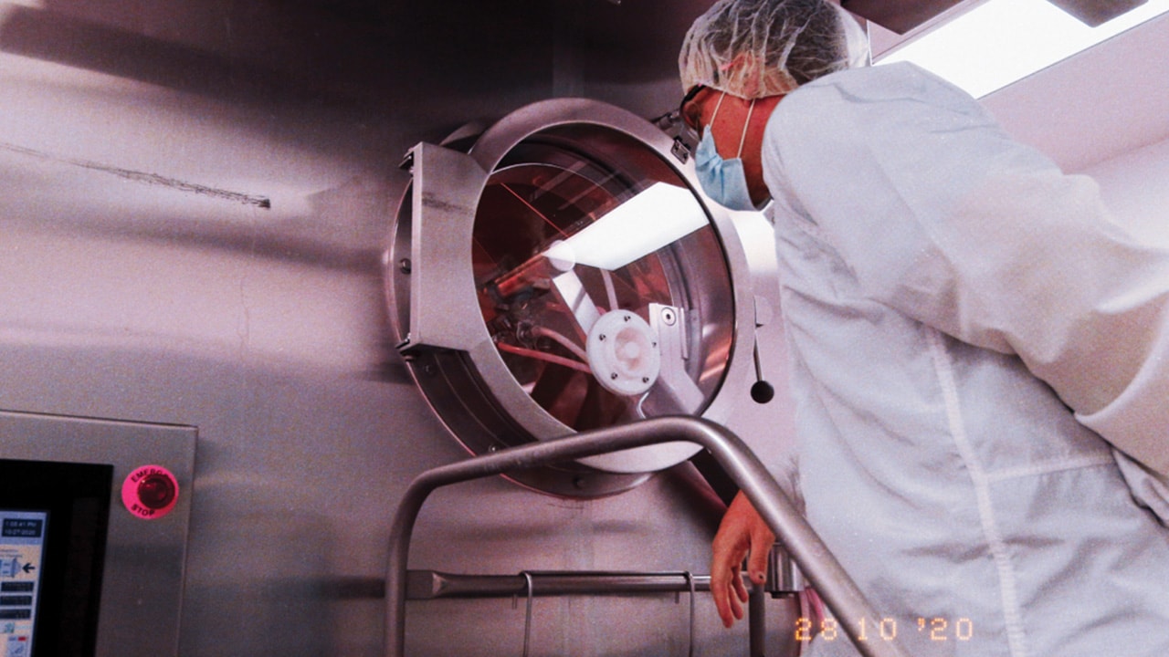 Production plant employee looking at equipment