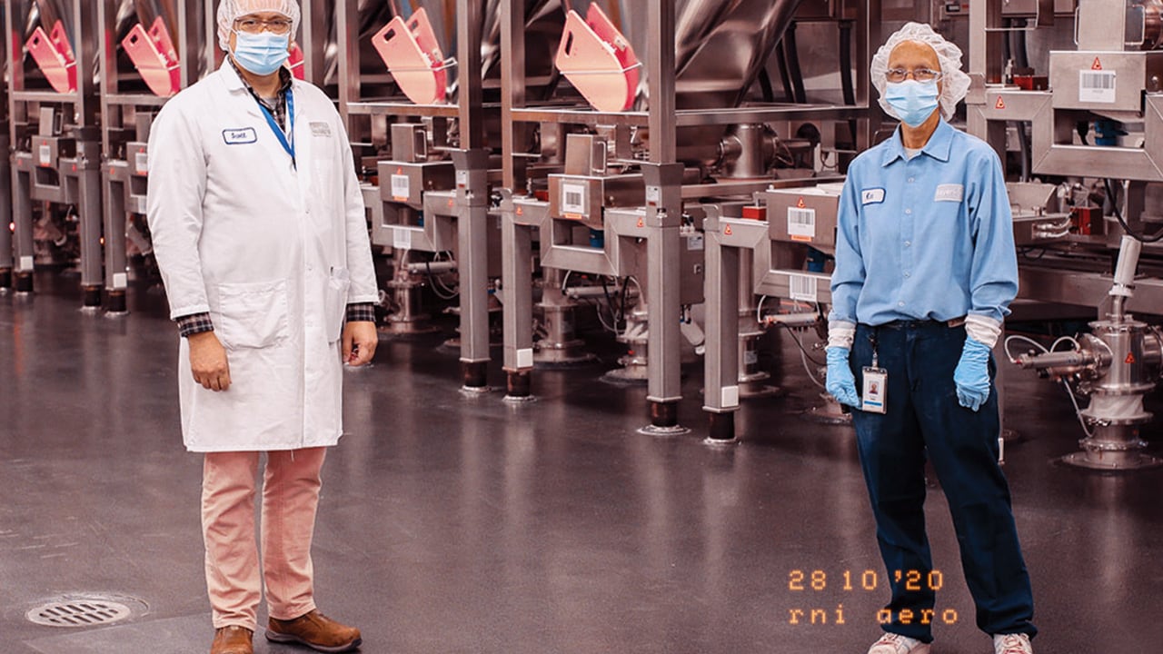 production employees standing 6 feet apart