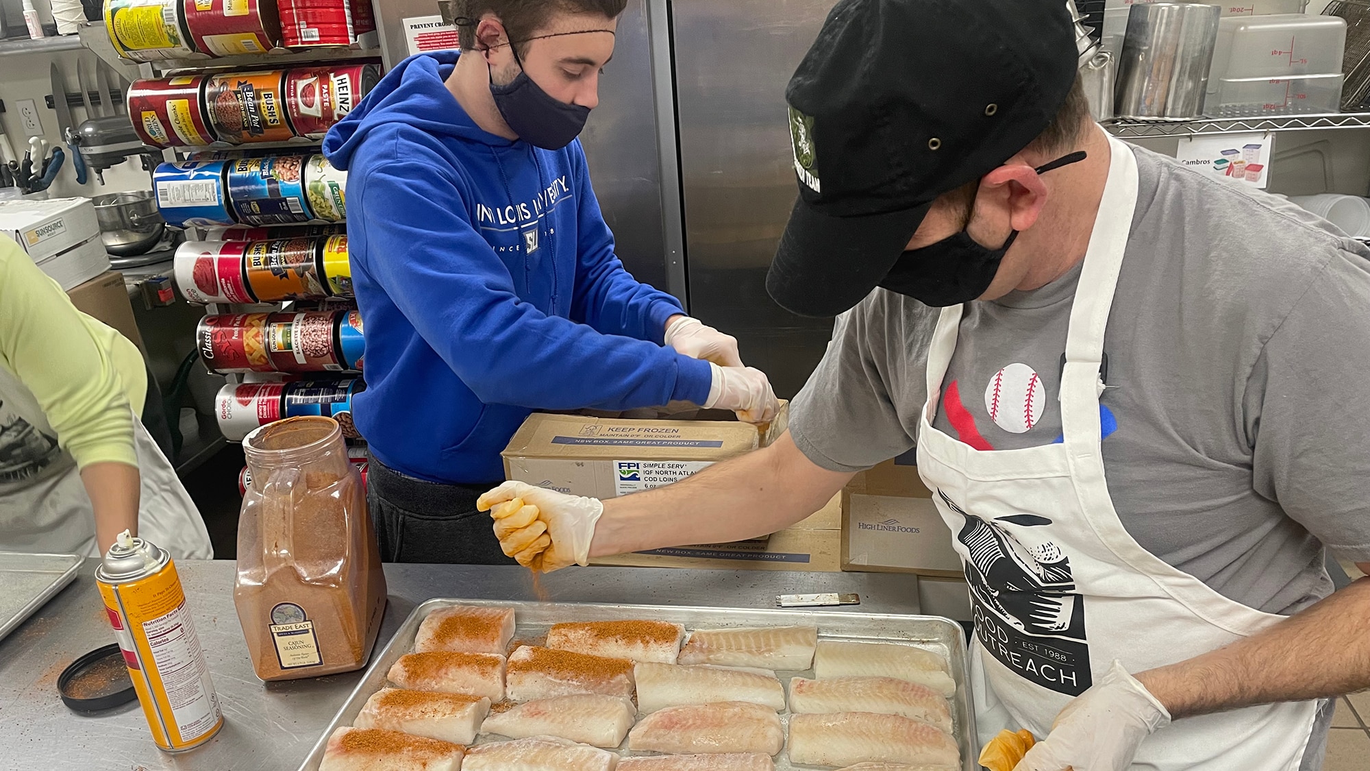 Volunteers help prepare a meal