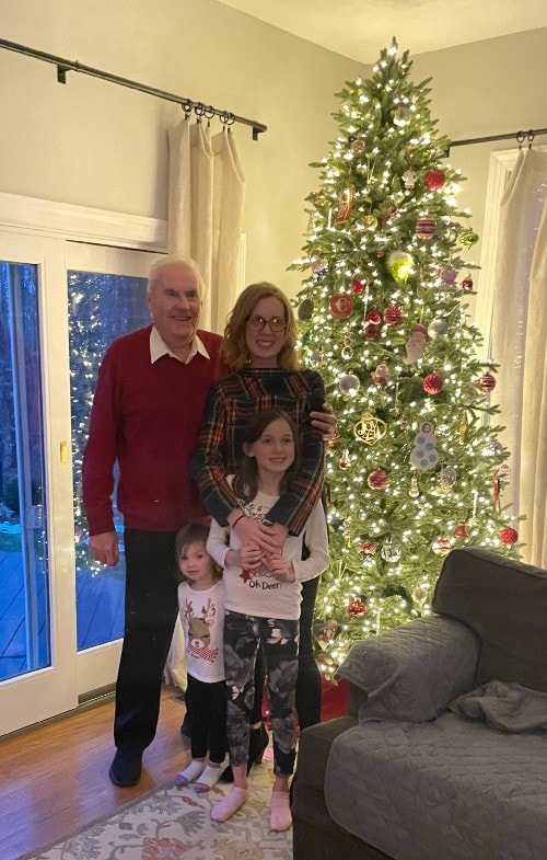 Family in front of christmas tree