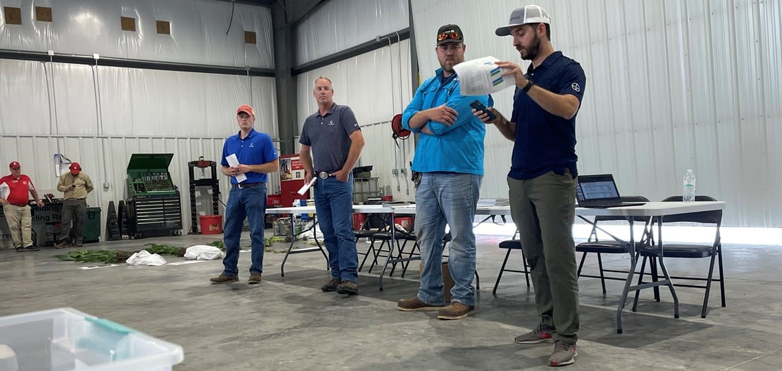 Bayer agronomists talking through options with UNL extension agents in the background. 