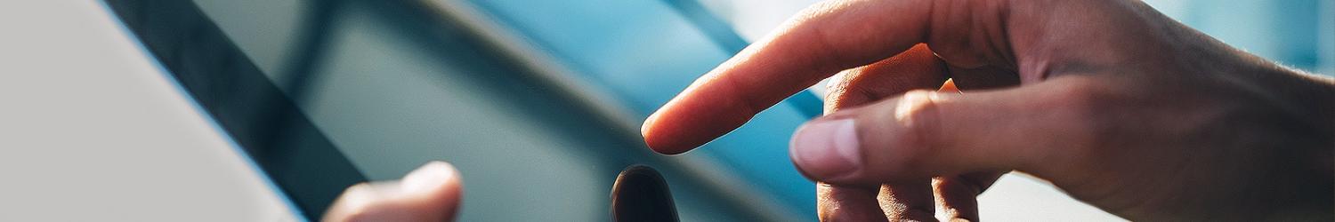 A person's finger touches a screen.