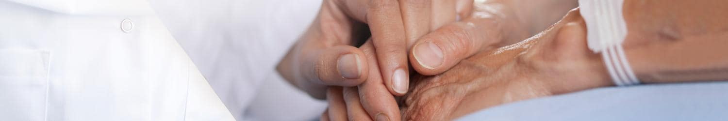 A doctor is holding a patient's hand.