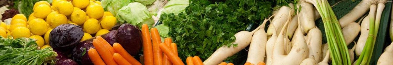 Various vegetables are arranged on a table.