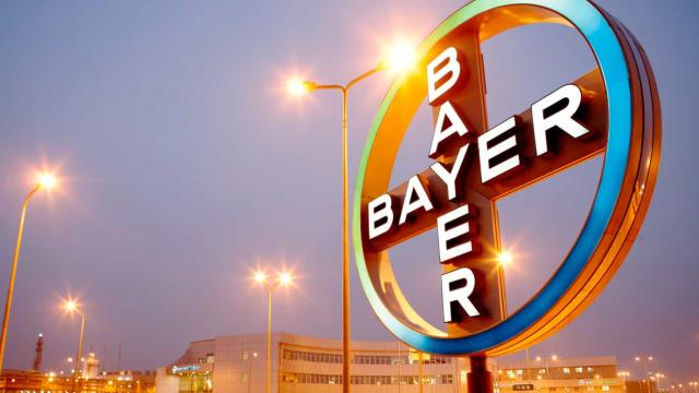 A sign with the word bayer on it in front of a building.