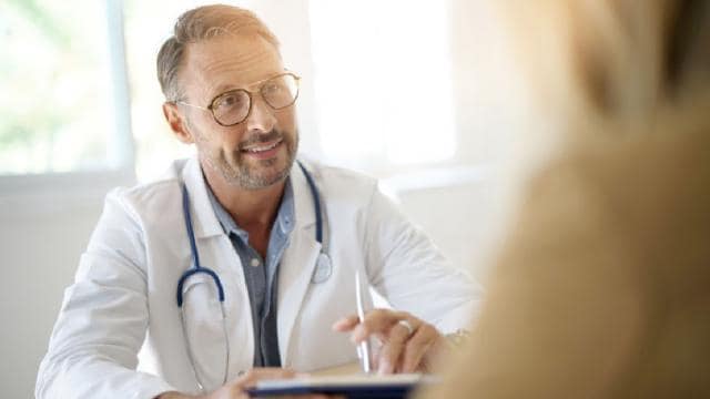 A male doctor talking to a female patient.