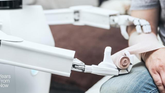 A person is sitting on a chair with a robotic arm.