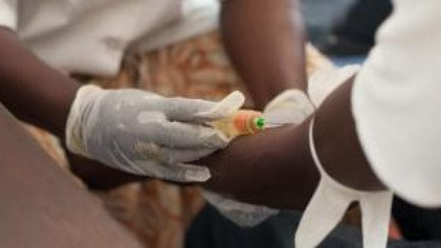 A person is getting a vaccine in a hospital.