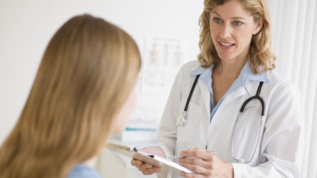 A female doctor is talking to a female patient.