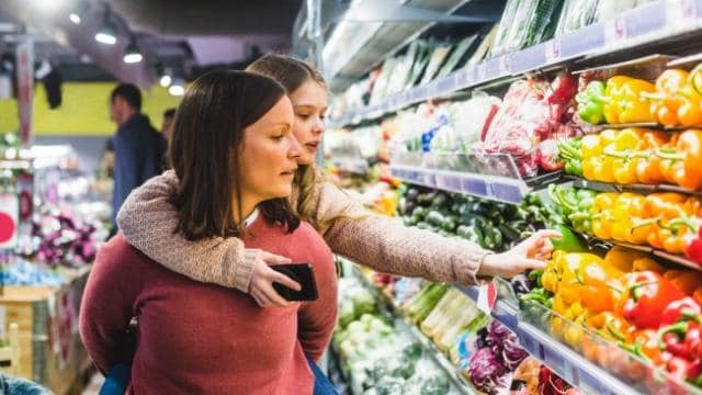 Mother and daughter shopping at market