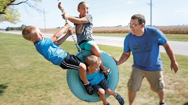 Farmer playing with children