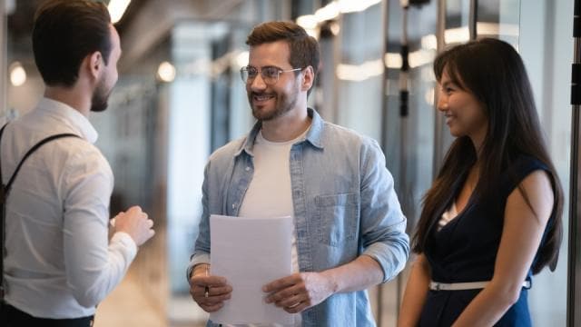 smiling-diverse-colleagues-talking