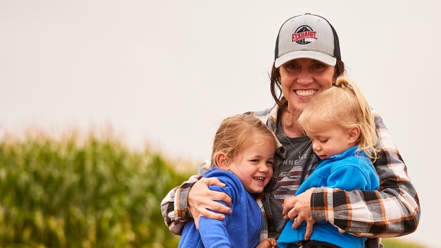 Farmer hugging her two kids