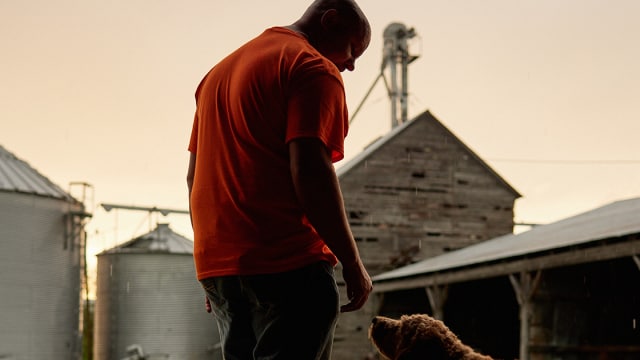 Farmer feeding his dog