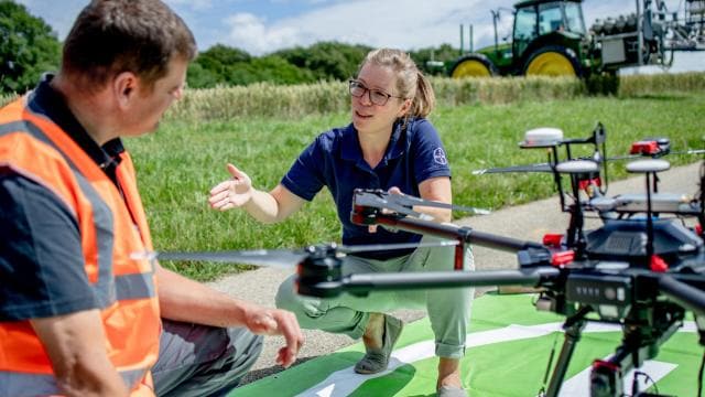 Employees setting a drone