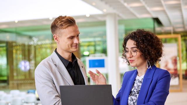 bayer employees in front of a laptop