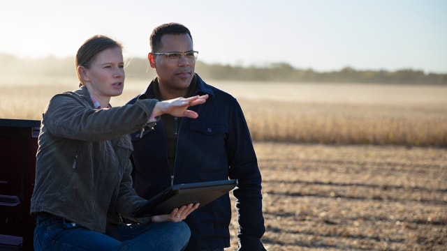 A farmer discussing weed management with a technical agronomist