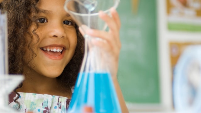 Girl decants liquid from tube