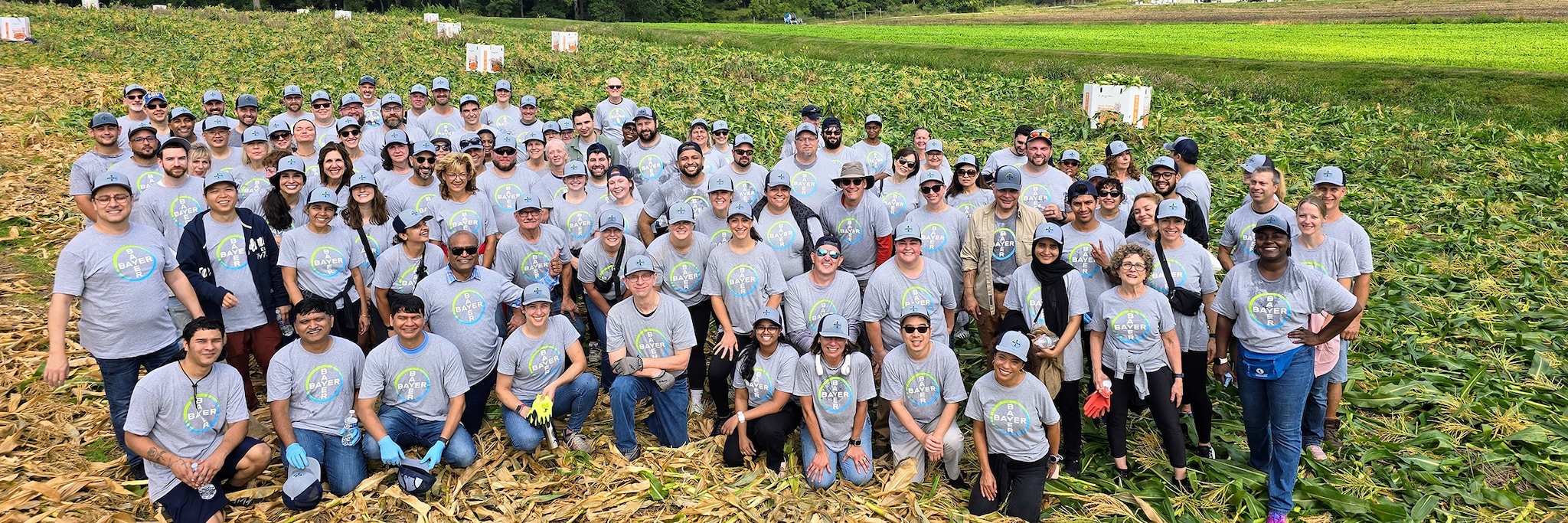 Bayer employees pose for a photo in the field