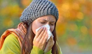 Woman blowing her nose