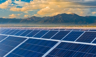 Solar panels with mountains in the background