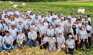 Bayer employees pose for a photo in the field