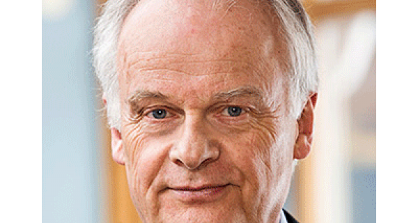 A close up of an older man in a suit.