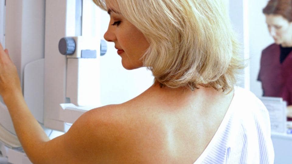 A woman looking at a mri machine.