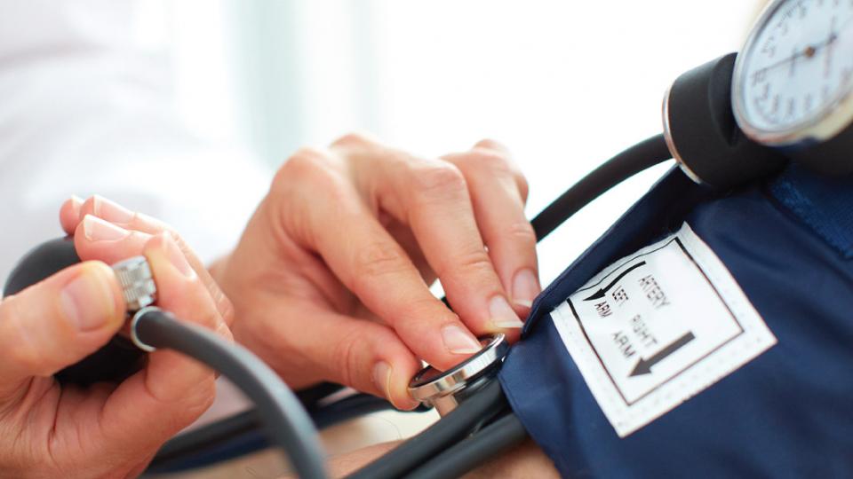 A doctor checking a patient's blood pressure.