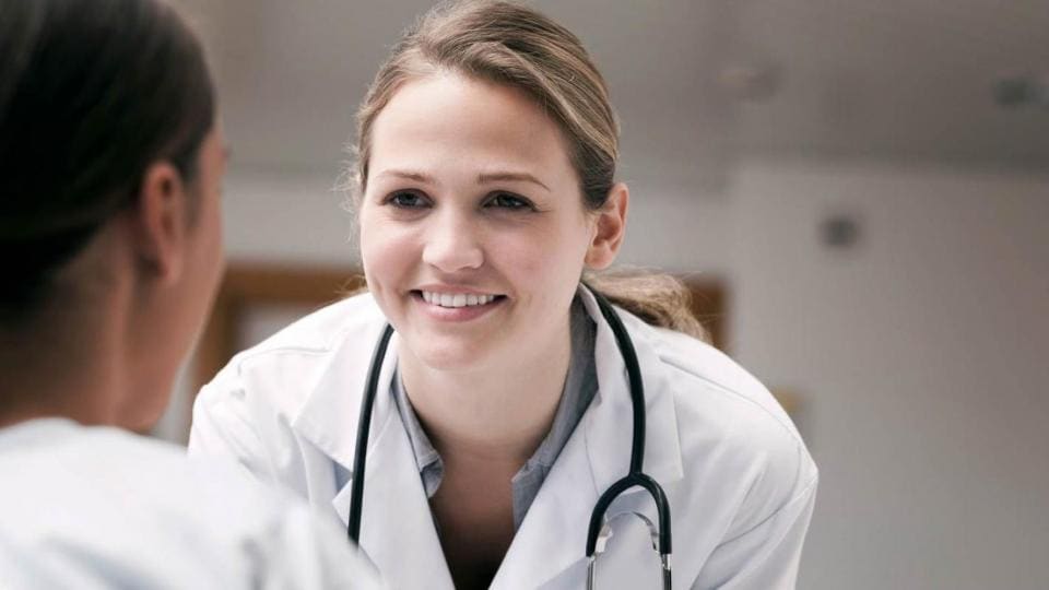 A female doctor is talking to a female patient.