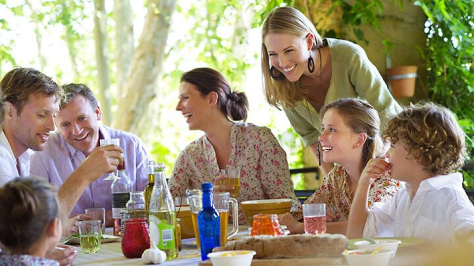 A family enjoying a meal outdoors.