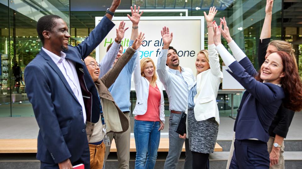 employees raise their arms