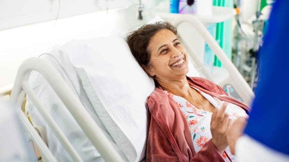 smiling patient in hospital bed