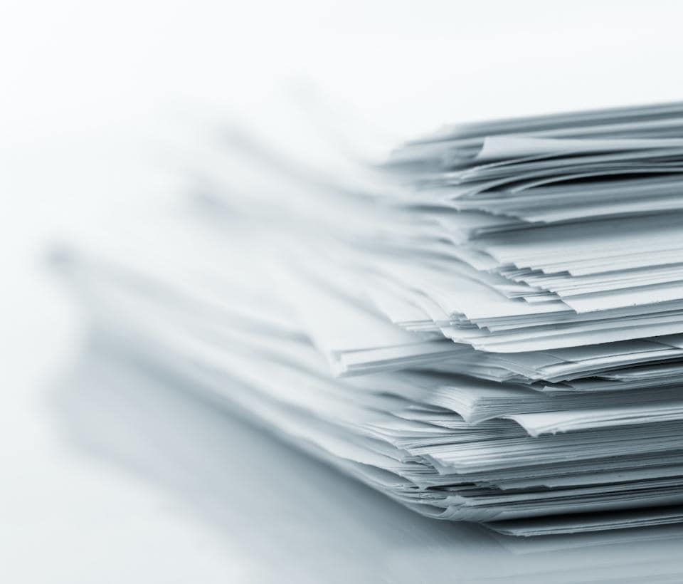 A pile of papers on a white background.