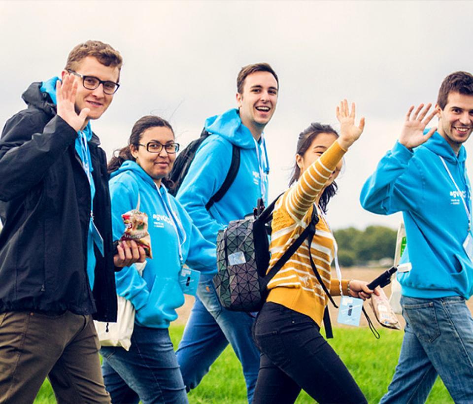 A group of people walking in a field.