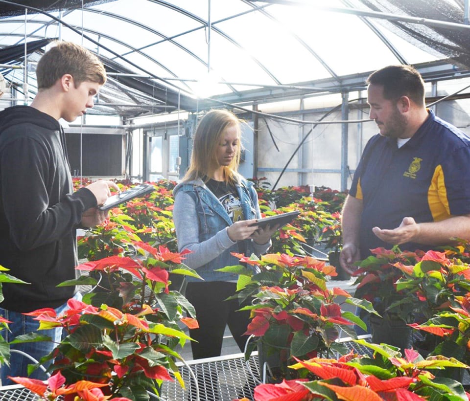 FFA students learning in a greenhouse