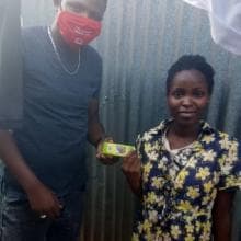 A man and a woman stand next to each other wearing a mask.