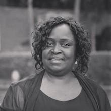 A black and white photo of a woman smiling.